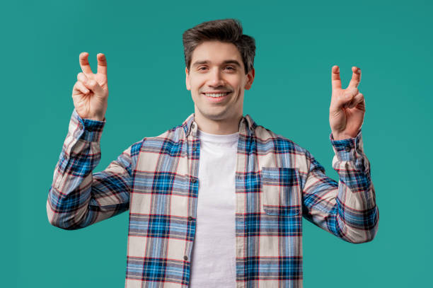 istock Sarcastic mature man with hands two fingers air quotes gesture on blue, sarcasm 2175042962