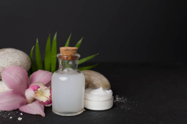 Composition with orchids, spa products on concrete table