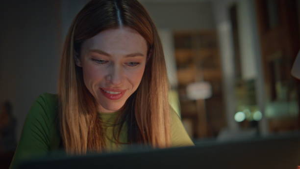 istock Closeup late worker looking laptop screen with smile at evening apartment. 2175048362