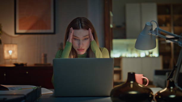 istock Disappointed freelancer video calling by laptop in dark home workplace close up. 2175049157