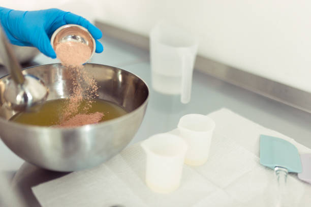 Unrecognizable female hands with protective gloves make natural soap