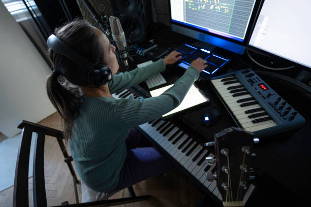 istock Woman Playing on MIDI Drum Pad Controller in Music Studio, Close-Up 2175050958