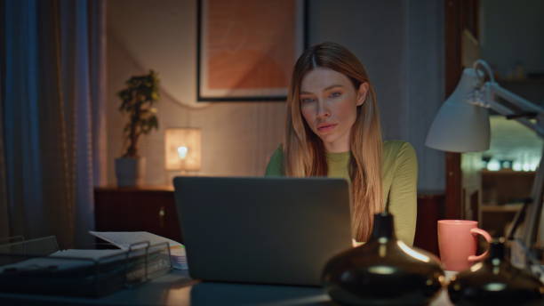 istock Serious freelancer work online in dark apartment close up. Woman making notes 2175054606