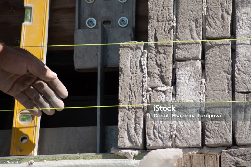 Alignment While Building Builder Aligning Bricks On Wall With Level Tools In Background Concept ...
