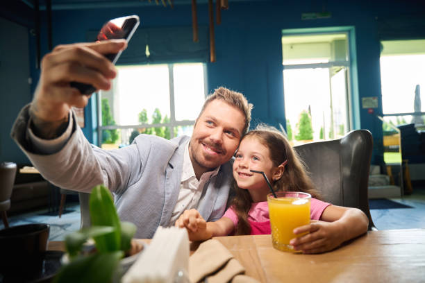 istock Dad takes selfie with daughter in restaurant 2175075235
