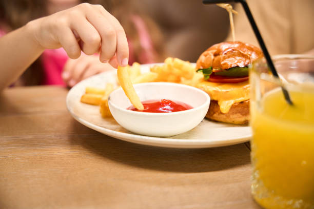 istock Child eats french fries with sauce 2175075251