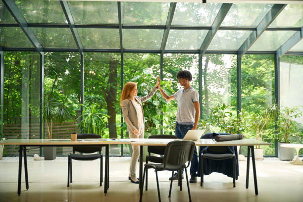 istock Man and woman discussing in a bright coworking space 2175080530