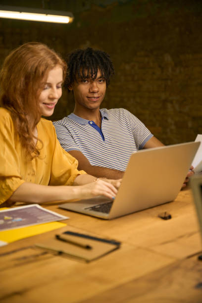 istock Young woman and man collaborating on a laptop 2175080612