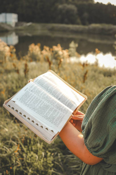 istock Girl with an open Bible in her hands, summer mood 2175080914