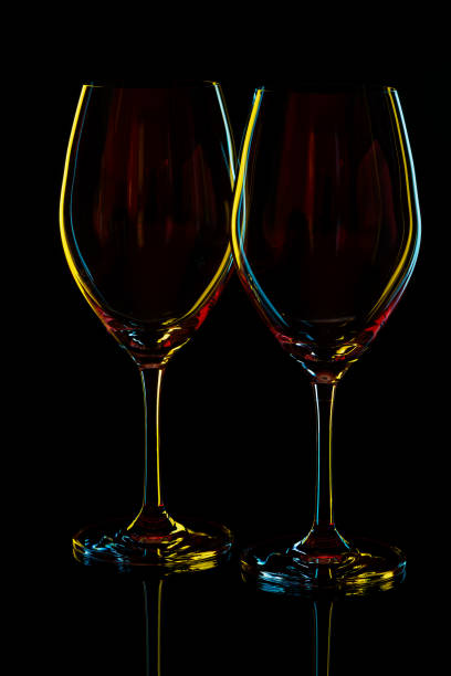 istock White Wine Glasses silhouette over Black Background. 2175082514