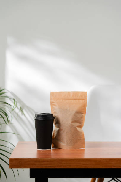 istock Three beverage containers and a paper bag on a wooden table 2175082874