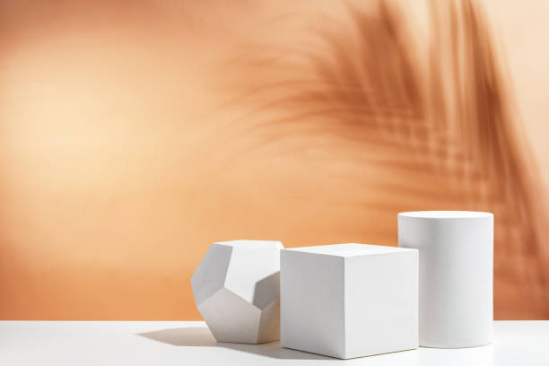 istock White geometric shapes arranged stylishly on a soft peach background in a minimalist setting 2175082896