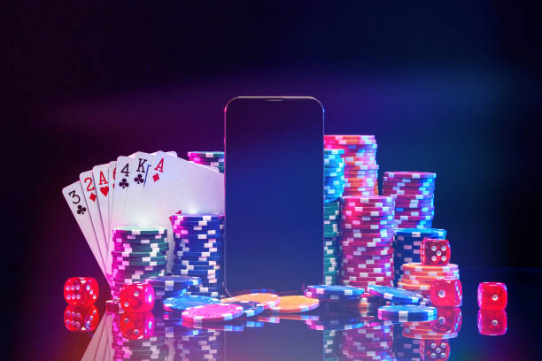 istock Brightly colored poker chips and playing cards arranged near a smartphone on a dark background in a gaming setting 2175082948