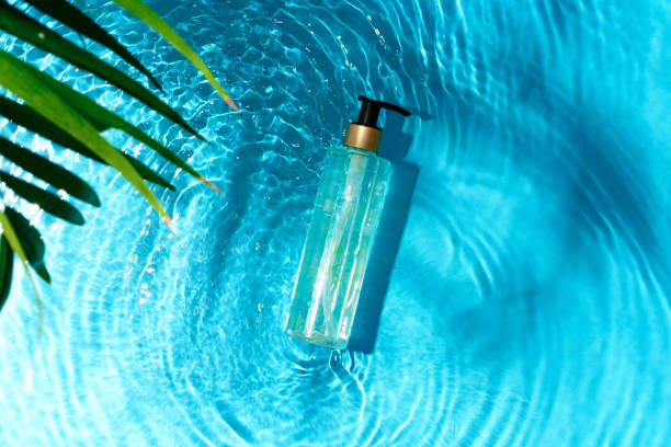 istock Green bottle floating on a clear blue swimming pool during bright daylight 2175082949
