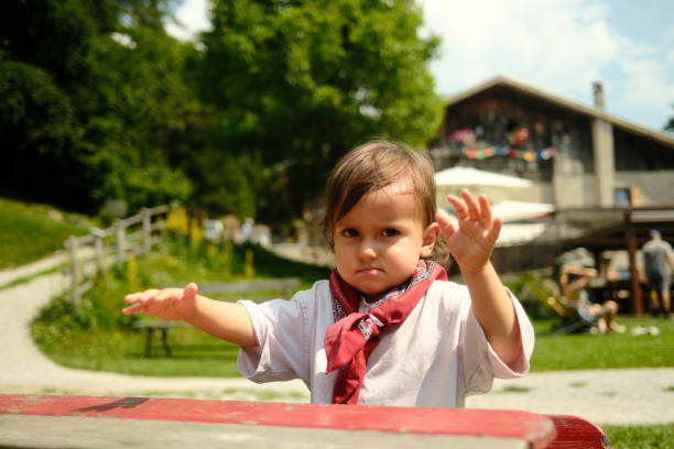 istock Young child raising their hands in protest at park 2175083254