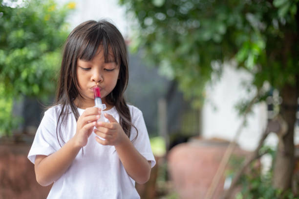 istock A young girl is blowing bubbles with a bubble wand 2175086245