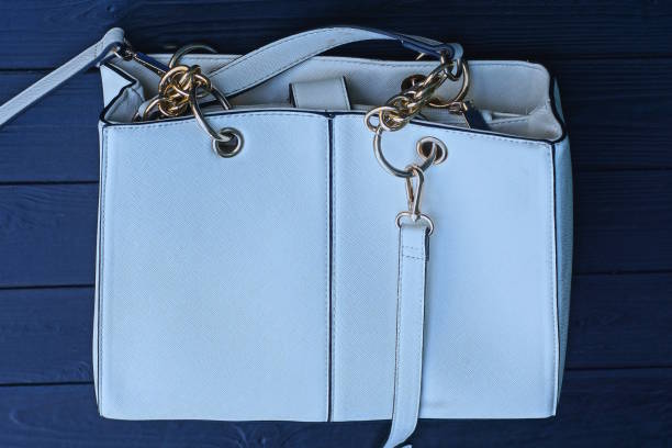 istock large white leather bag lies on a black wooden table 2175086414