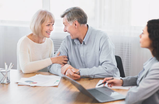 istock Mature couple talking to financial advisor at office 2175087235