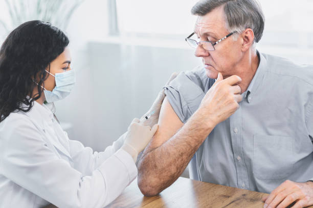 istock Mexican doctor doing vaccination to elderly man 2175087363