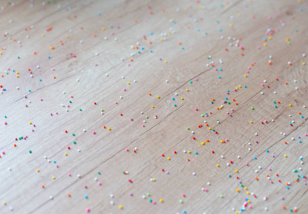 istock Confectionery fine sprinkles for cakes are scattered on the kitchen table. Multi-colored confectionery balls on the table. 2175089769