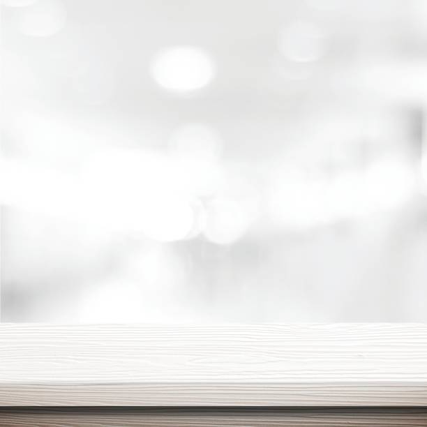 istock Table and blur background, White wooden counter over blur bokeh light background, table top, shelf for food and retail shop, store product display backdrop, banner, mockup, template 2175091469