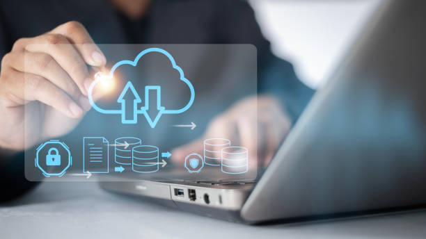 istock A person is using a laptop with a blue screen that has a cloud and arrows on it 2175117450