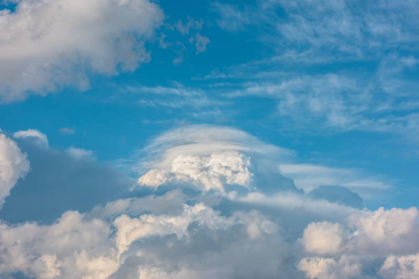 istock Huge dramatic lenticular cloud on white lush cloudy hill in blue sky. Beautiful cloudscape with big UFO shaped cloud in center. Scenic skyscape with altocumulus clouds. Awesome unusual cloudy skies. 2175117793