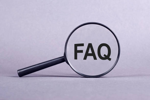 istock Magnifying glass with FAQ - frequently asked question, inscription on a gray background. 2175118390