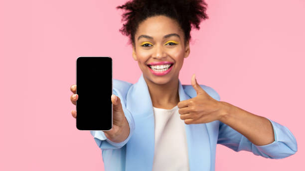 istock Young afro woman showing blank black cell phone screen 2175118910