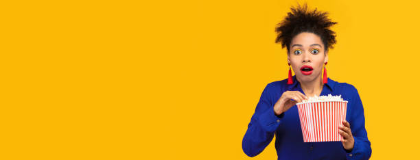 istock Shocked black girl with popcorn staring at camera 2175119093