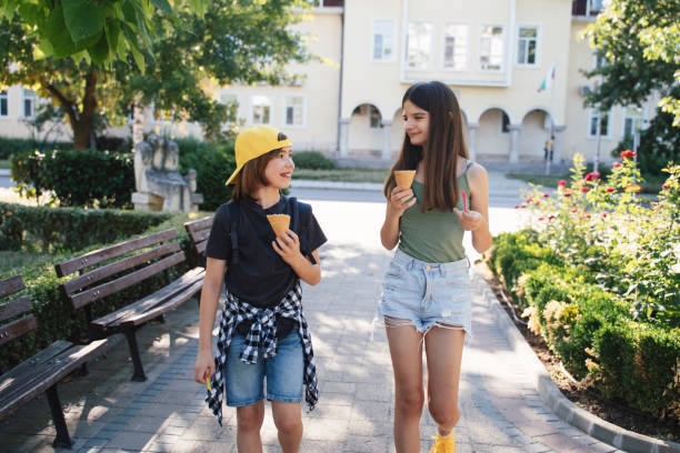 istock Young friends enjoy ice cream cones on a walk 2175119864