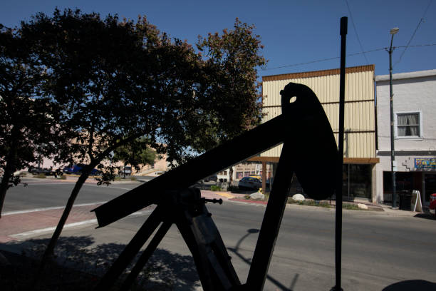 Taft, California, USA - September 20, 2024: Afternoon sunlight shines on an oil pumpjack in the historic downtown core.