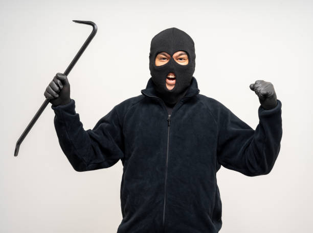 istock Thief in uniform black jacket various pose on isolated background. The Robber terrorism criminal escapes with balaclava and crowbar entering a house for stealing Housebreak 2175140299