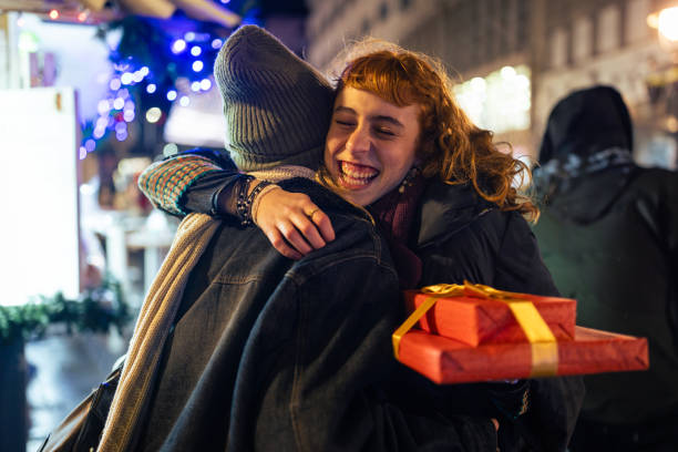 Warm Hug and Gift Exchange Under Festive Night Lights