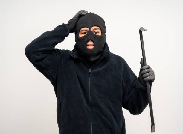 istock Thief in uniform black jacket various pose on isolated background. The Robber terrorism criminal escapes with balaclava and crowbar entering a house for stealing Housebreak 2175143058
