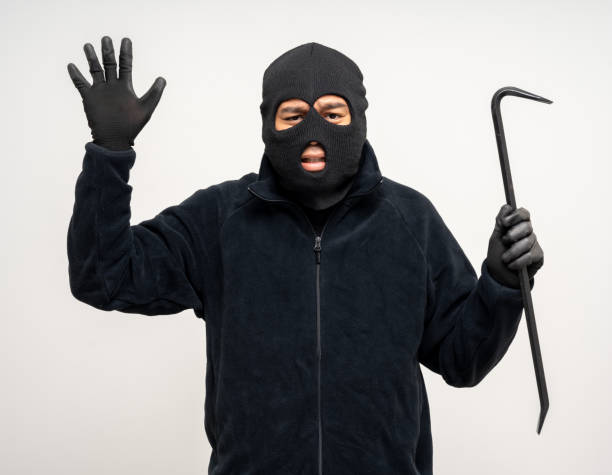 istock Thief in uniform black jacket various pose on isolated background. The Robber terrorism criminal escapes with balaclava and crowbar entering a house for stealing Housebreak 2175143760