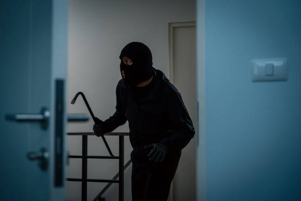 istock Thief in uniform black jacket various action housebreak. The Robber terrorism criminal escapes with balaclava and crowbar entering a house for stealing Housebreak at night 2175143806