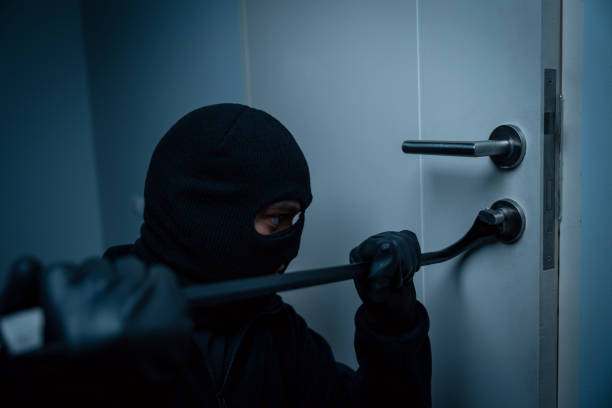 istock Thief in uniform black jacket various action housebreak. The Robber terrorism criminal escapes with balaclava and crowbar entering a house for stealing Housebreak at night 2175147338