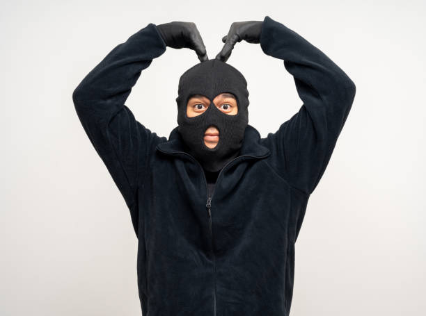istock Thief in uniform black jacket various pose on isolated background. The Robber terrorism criminal escapes with balaclava and crowbar entering a house for stealing Housebreak 2175148449