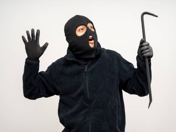 istock Thief in uniform black jacket various pose on isolated background. The Robber terrorism criminal escapes with balaclava and crowbar entering a house for stealing Housebreak 2175148471