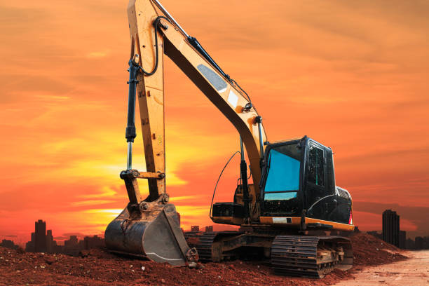 istock Yellow Excavators are digging the soil in the construction site. 2175150054