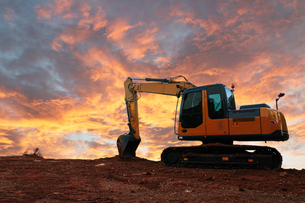 istock Yellow  Excavators are digging the soil in the construction site 2175150399