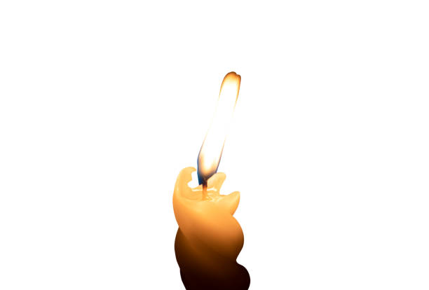A single burning candle flame or light glowing on a small spiral white candle is isolated on white background with clipping path.
