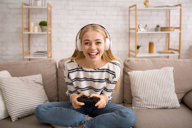 istock Happy girl in wireless headset playing videogame 2175152939