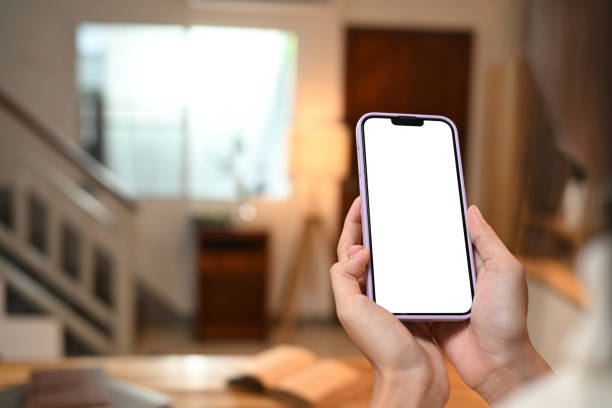istock Close up image of unrecognizable woman holding smartphone with blurred kitchen background 2175155248