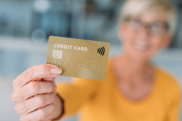 istock Woman holding a credit card. 2175155639