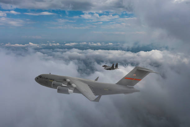 istock Jet fighter aircrafts escorting a C-17 Globemaster III, F-15B Eagle, US Air Force. 2175176540