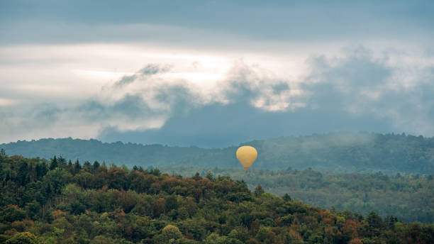 Hot air balloon floating in a misty mountain