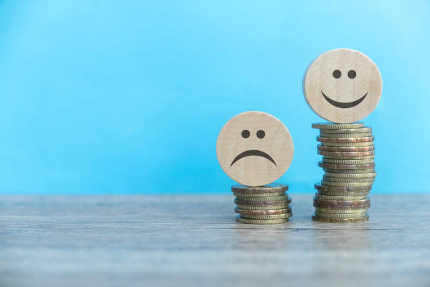 istock Happy and sad face over a different level of coin stack. 2175179866