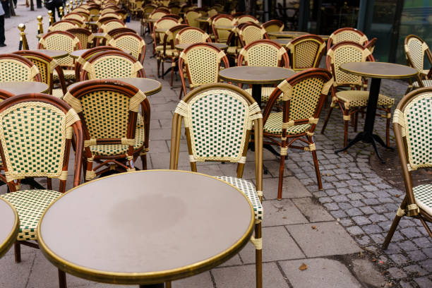 istock Empty wicker chairs and tables at outdoor European cafe 2175180412